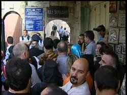 Thousands of Orthodox Christian worshippers clutching candles crowded into Christianity's holiest shrine on Saturday to celebrate Easter Week's holy fire ritual. News Clip