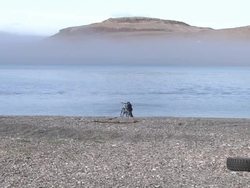 Inuit Child pushing bike on beach of Cambridge Bay News Clip