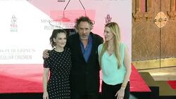 Tim Burton and Winona Ryder at the Tim Burton To Place Handprints-Footprints In Cement At TCL Chinese Theatre IMAXï¿½ Forecourt Stock Footage