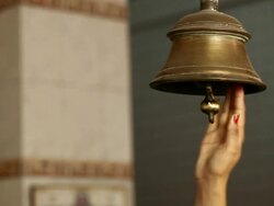 Woman ringing bell of a temple  Stock Footage