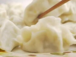 Fiddle dumplings with chopsticks Stock Footage