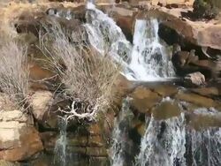 WS AERIAL TU View of Water fall around red rocks / Moab, Utah, United States Stock Footage