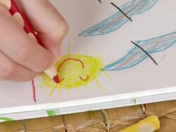 HD: Girl Drawing Smiley Sun Stock Footage