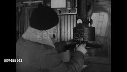 1936: NEW ENGLAND: FISHING INDUSTRY: MS Frozen ice covered deck & rails of steam trawler. INT Boat w/ fisherman checking depth gauge standing next to compass. DRAMATIZATION: Crew eating at table. INT Ship's quarters w/ men playing cards, resting. Instructional Video
