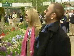 Ringo Starr and his wife, Barbara Bach, walk through Chelsea Flower Show Stock Footage