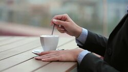 Woman stirring cappuccino coffee Stock Footage