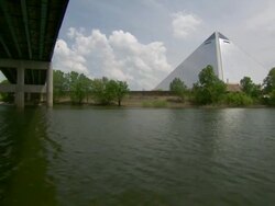 WS POV View of pyramid arena and boat passing below bridge / Memphis, Tennessee, United States Stock Footage
