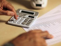 Comptroller checking financial transactions on a calculator  Stock Footage