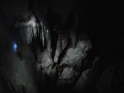 MS Looking down and across on ice climber in night from distance and Climber has headlamp on scaling up ice / Ouray,CO,USA Stock Footage