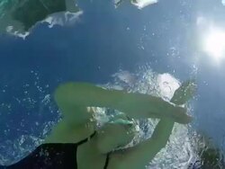 MS SLO MO Woman swimming front crawl in pool, underwater shot taken from below looking up. Stock Footage