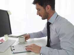 Young businessman drinking coffee while working at the office Stock Footage