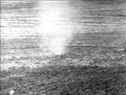B/W 1936 small dust devil spinning over dusty ground / Dust Bowl Stock Footage