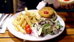 Girl pouring ketchup over her meal Stock Footage