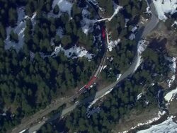 WS AERIAL View of Train moving in between forest / Switzerland Stock Footage