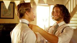 Groomsman helping groom with bowtie before wedding Stock Footage