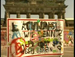 CU zooming to WA, Sign obscured by messy colourful graffiti, Brandenburg Gate and Berlin Wall in background, Berlin Stock Footage