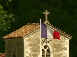 ZO French Tricolour and church / Domremy-la-Pucelle, Lorraine, France Stock Footage