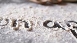 Close up of words written in flour Stock Footage