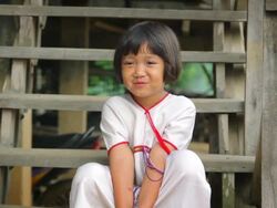Karen girl smiled shyly poses for the stairs Stock Footage