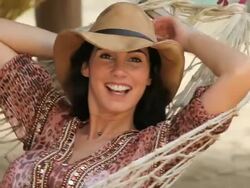 Good looking young Woman in a Hammock, smiles at camera Stock Footage