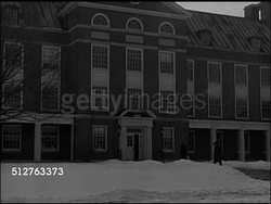 1947: NEW JERSEY: WS Institute for Advanced Study, Fuld Hall. Men walking into building. WS Dr. J. Robert Oppenheimer sitting w/ four men in living room. Instructional Video
