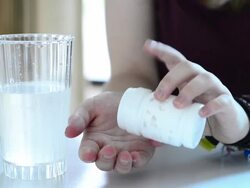Pouring pills into hands Stock Footage