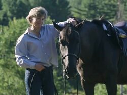  MS Equestrian petting a horse in a wooded field / Stowe, Vermont, United States Stock Footage