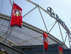 Tilted mid shot of Leverkusen flag and crest above Stock Footage