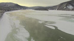 A thin crust of ice covers the edges of the Yukon River in Canada. Stock Footage