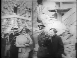 B/W 1940 PAN King George VI + Queen Elizabeth walk near bombed out building / London / educational Stock Footage