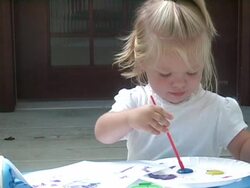 Little girl paints with the color blue. Stock Footage