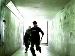 Slow motion long shot three freerunners running down hallway and jumping + flipping off walls Stock Footage