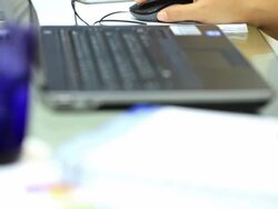 Crane shot: Working at home with laptop mouse, closeup Stock Footage