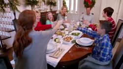 Family toast happily and clink glasses before Christmas dinner (dolly-shot) Stock Footage
