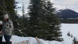 Family toasting marshmallows at fire pit snowy patio Stock Footage