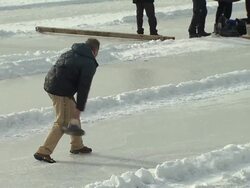 Nymphenburg, man shot curling stick over ice, some other people Stock Footage