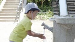 The child who washes a hand in a park Stock Footage