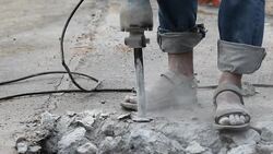 Drilling asphalt road Stock Footage