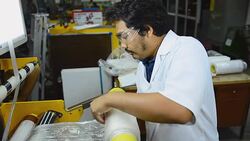 panning: a senior engineer roll blown plastic film on blown film extruder Stock Footage