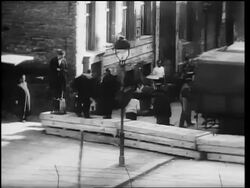 B/W 1961 people loading trucks with belongings near Berlin Wall under construction / East Berlin Stock Footage