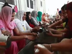 MS Group of women washing utensils as Karseva (selfless service) at Golden Temple (Sikh temple) / Amritsar, Punjab, India Stock Footage