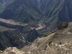 WS Yak caravan descending to distant valley / near Ringmo village, Himalayas, Upper Dolpo, Nepal   Stock Footage