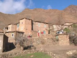 MS PAN Shot of small village at base of atlas mountains / Marrakech, Tensift, Morocco  Stock Footage