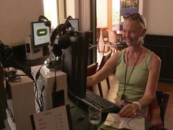 MS Smiling woman using computer in internet cafe, Bangkok, Thailand Stock Footage