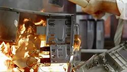 SLO MO LD Computer in flames being hit by hammer Stock Footage