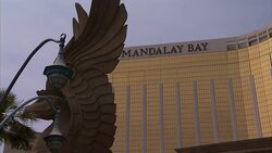 The facade of Mandalay Bay Resort and Casino gleams behind a winged griffin statue in Las Vegas, Nevada. Stock Footage