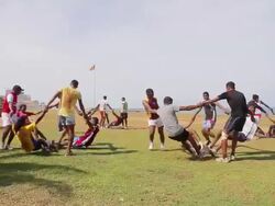 WS Group of soccer players do an unusual training exercise on Galle Face Green esplanade Stock Footage