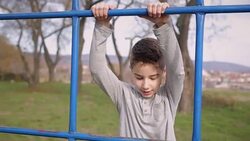 Boy climb on the equipment for playing Stock Footage
