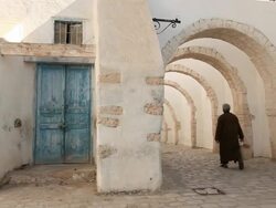 Old man walking in olg Djerba Stock Footage
