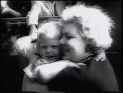 B/W 1961 close up woman hugging small boy outdoors / East German refugees / beginning of Berlin Wall Stock Footage
